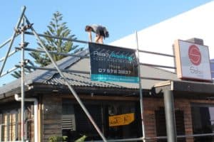 Roof repairs on a small commercial building using long run roofing